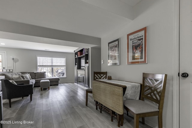 interior space featuring baseboards and wood finished floors