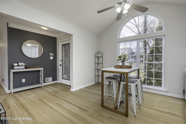 dining area featuring baseboards, light wood-style floors, and a healthy amount of sunlight