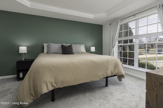 bedroom with carpet flooring, baseboards, a tray ceiling, and ornamental molding