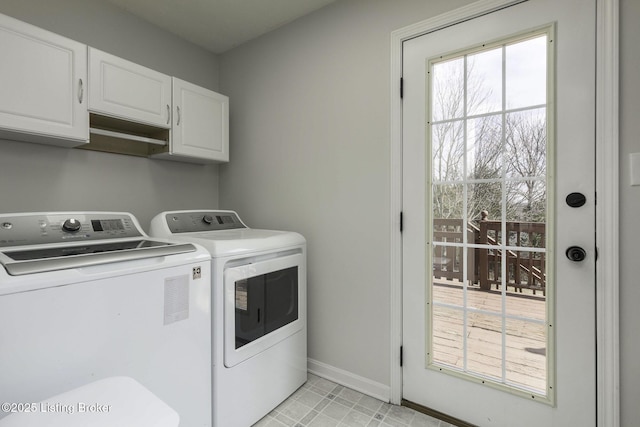 laundry area with washer and dryer, baseboards, and cabinet space