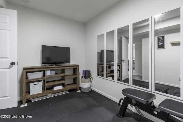 workout area featuring baseboards