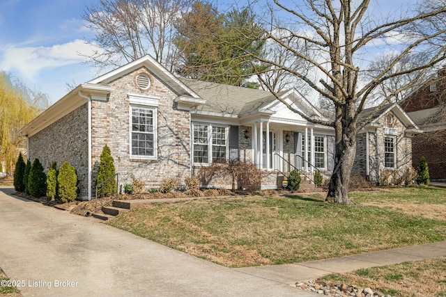 ranch-style house with a front yard and brick siding