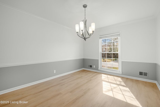 empty room with visible vents, baseboards, and light wood-style flooring