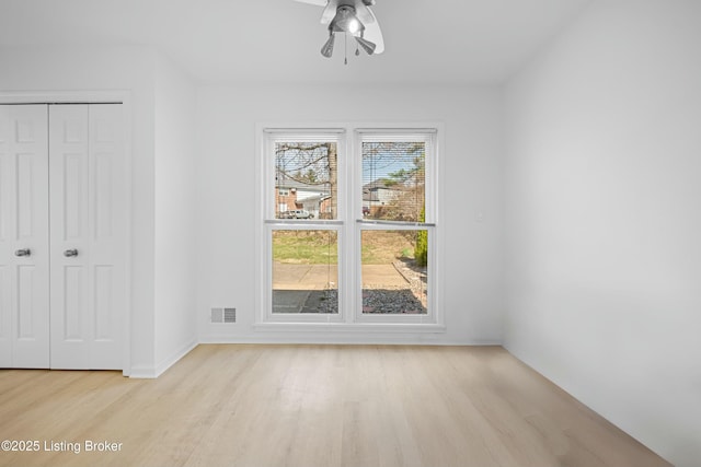 unfurnished dining area with visible vents, ceiling fan, baseboards, and light wood-style floors