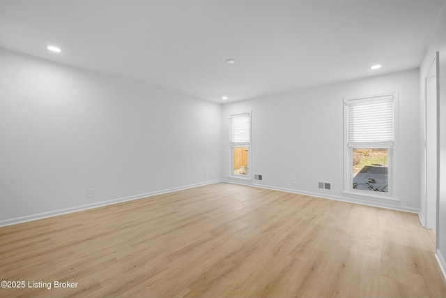 empty room with recessed lighting, visible vents, a healthy amount of sunlight, and light wood-style flooring