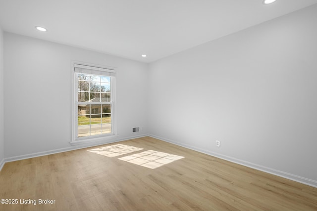 unfurnished room with light wood-style flooring, recessed lighting, visible vents, and baseboards