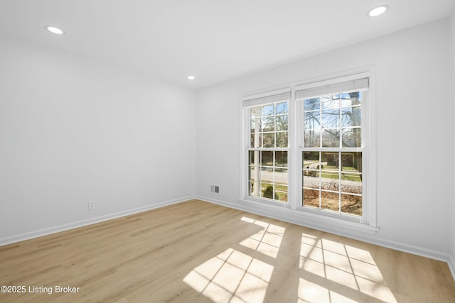 empty room with recessed lighting, visible vents, baseboards, and light wood-style floors