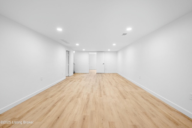 unfurnished living room with recessed lighting, baseboards, and light wood finished floors