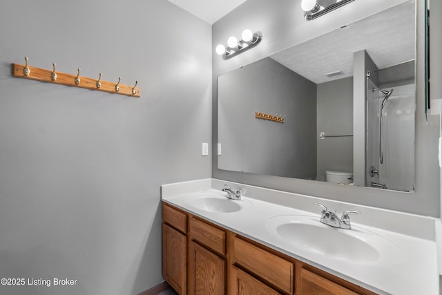 full bathroom with toilet, a shower, visible vents, and a sink