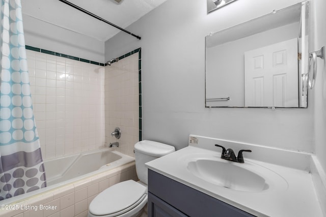 bathroom featuring toilet, shower / tub combo with curtain, and vanity