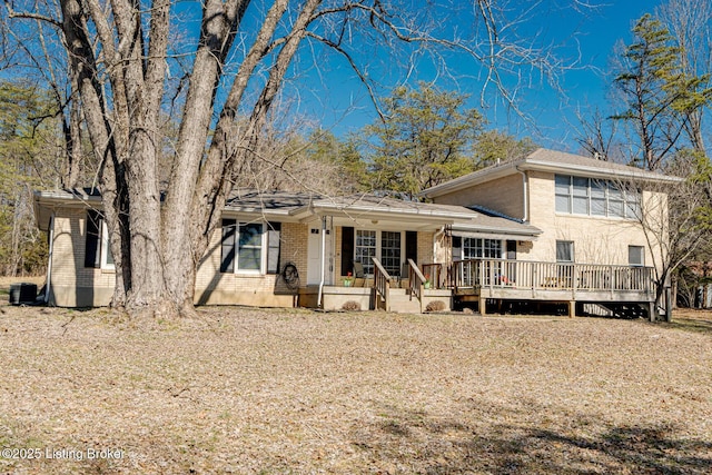 tri-level home featuring brick siding and central AC unit