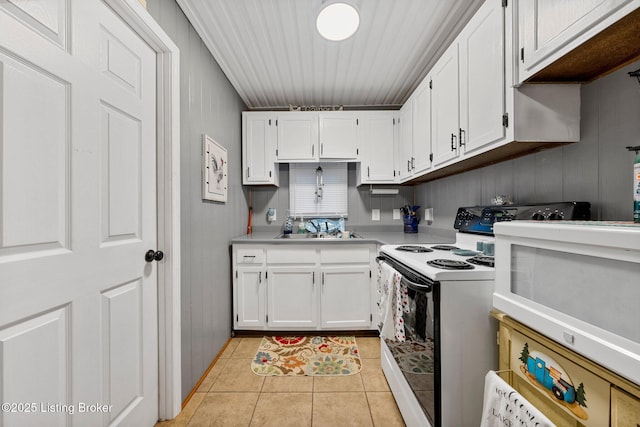 kitchen featuring a sink, white cabinetry, white appliances, light tile patterned flooring, and light countertops