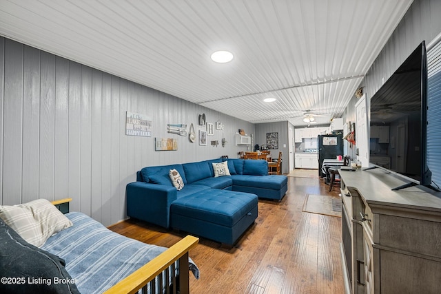 living room with hardwood / wood-style flooring and ceiling fan