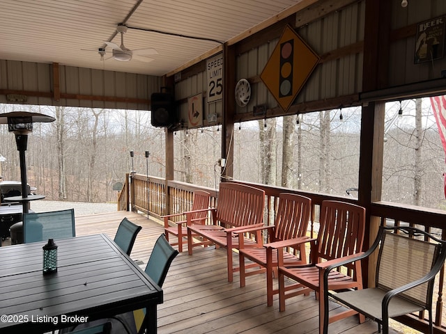 wooden deck with a ceiling fan