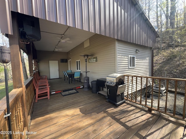 wooden terrace with grilling area and outdoor dining area