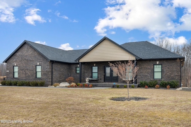 view of front of home with brick siding and a front lawn