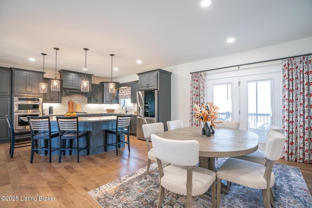 dining area with recessed lighting and light wood-type flooring