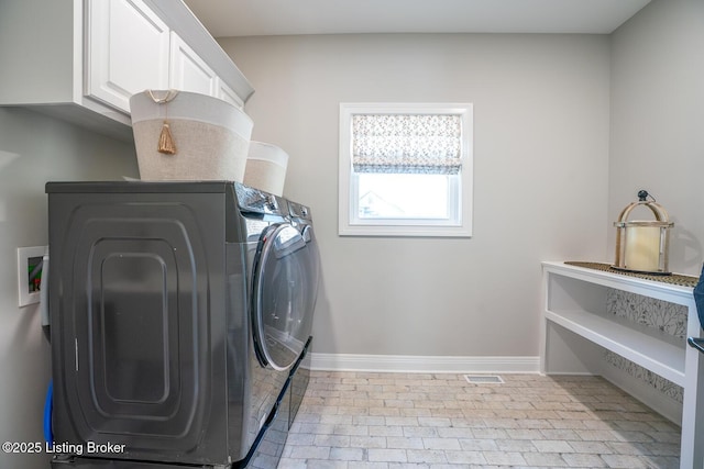 laundry room featuring visible vents, baseboards, cabinet space, brick floor, and independent washer and dryer