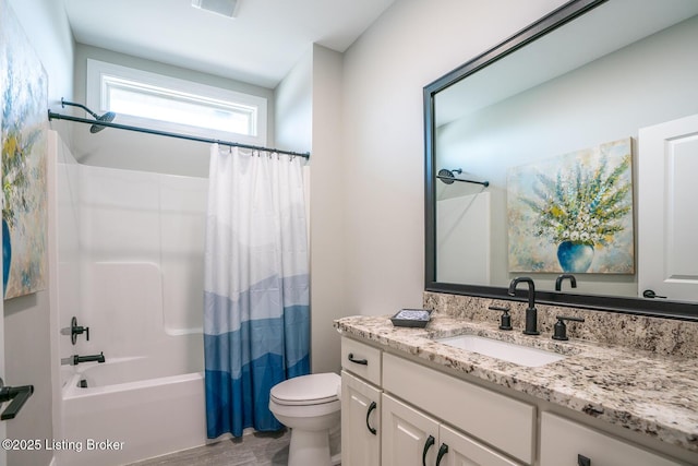 full bath featuring toilet, vanity, and shower / bathtub combination with curtain