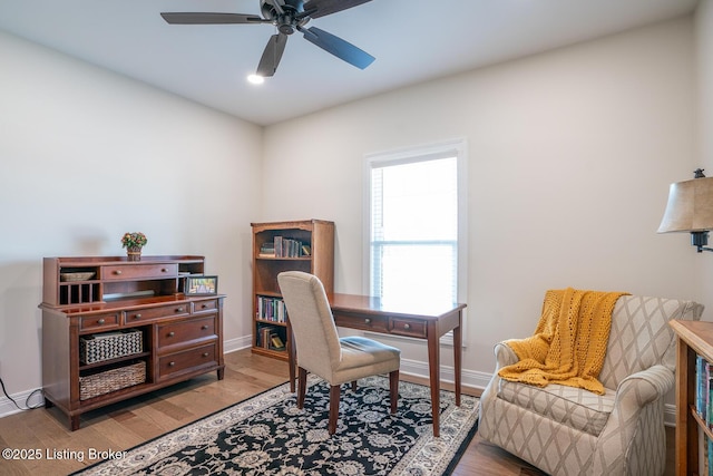 office with a ceiling fan, baseboards, and wood finished floors