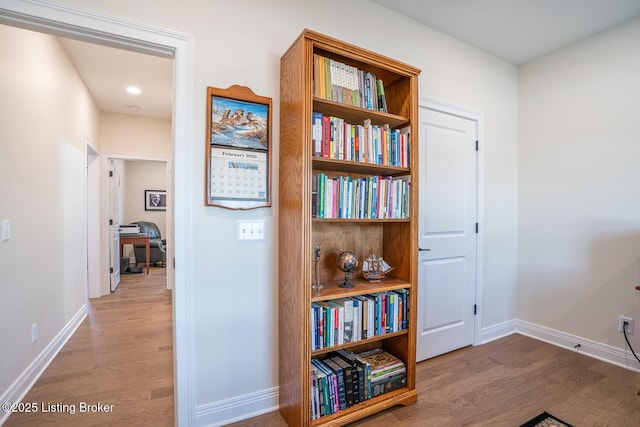 hall with wood finished floors and baseboards