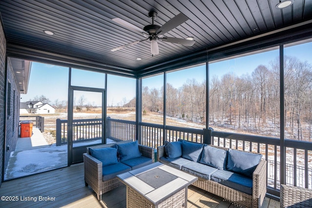 sunroom featuring a ceiling fan