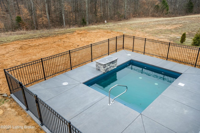 view of swimming pool with a patio area, fence, and a fenced in pool