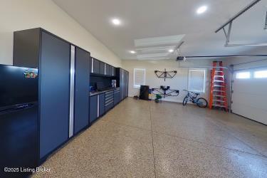 kitchen featuring blue cabinetry, light speckled floor, and freestanding refrigerator