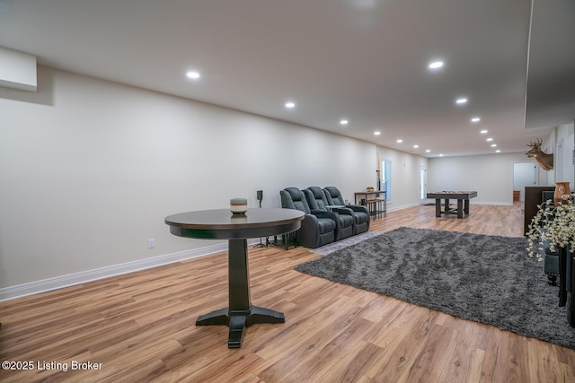 living room featuring recessed lighting, wood finished floors, and baseboards