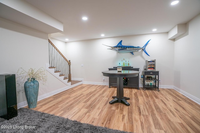 interior space featuring recessed lighting, baseboards, and wood finished floors