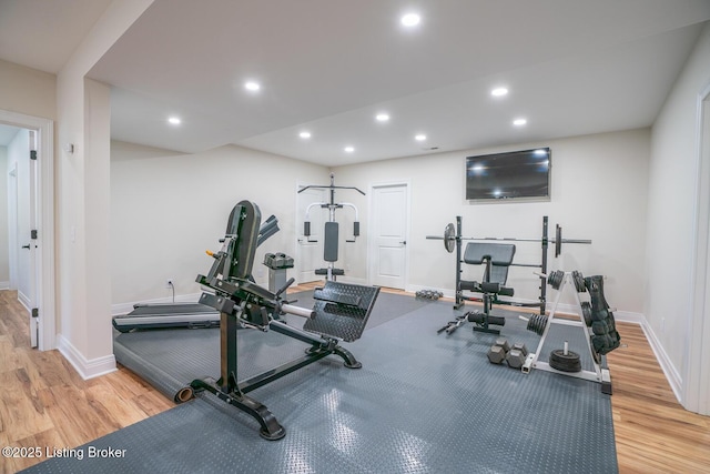 workout room with recessed lighting, baseboards, and wood finished floors