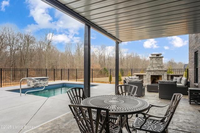 view of pool featuring a fenced in pool, a patio, fence, and an outdoor living space with a fireplace