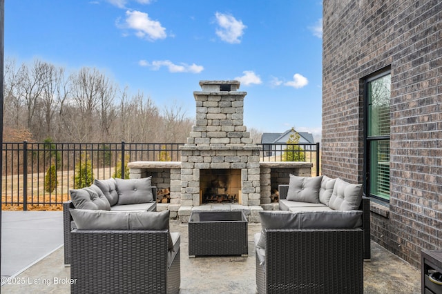 view of patio / terrace with an outdoor living space with a fireplace and fence