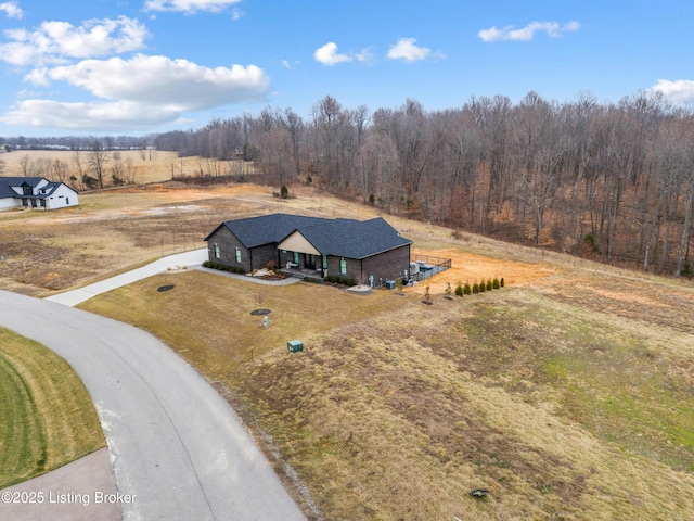 birds eye view of property with a rural view and a view of trees