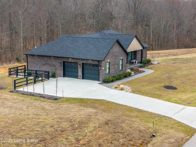 view of front of house with brick siding, a shingled roof, a front lawn, fence, and a garage