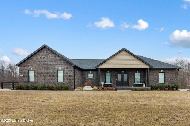 view of front of home featuring brick siding, a porch, and a front lawn