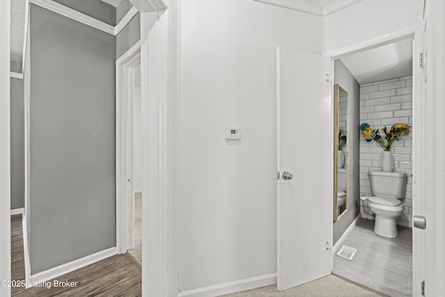 bathroom featuring visible vents, toilet, tile walls, and baseboards