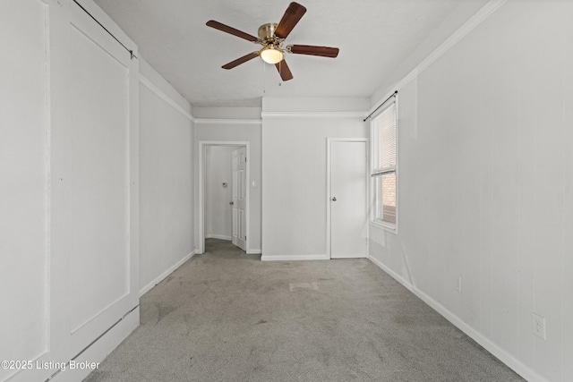 unfurnished bedroom with baseboards, ceiling fan, and carpet floors