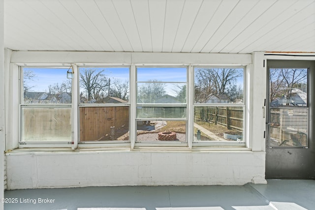 unfurnished sunroom with wood ceiling