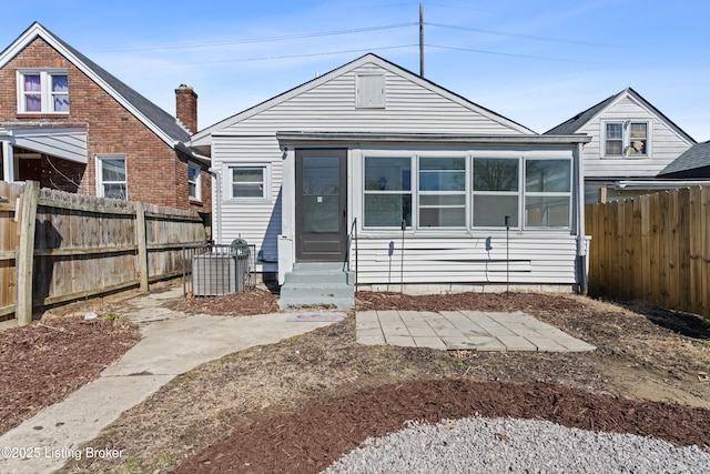 view of front of house featuring entry steps and a fenced backyard