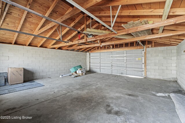 garage with concrete block wall