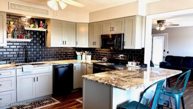 kitchen featuring electric range, a sink, black dishwasher, backsplash, and ceiling fan