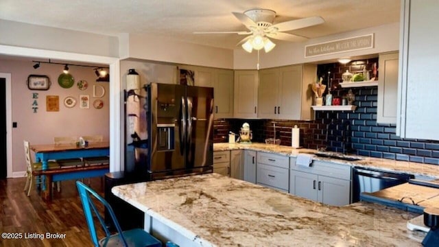 kitchen featuring light stone counters, black appliances, tasteful backsplash, and open shelves