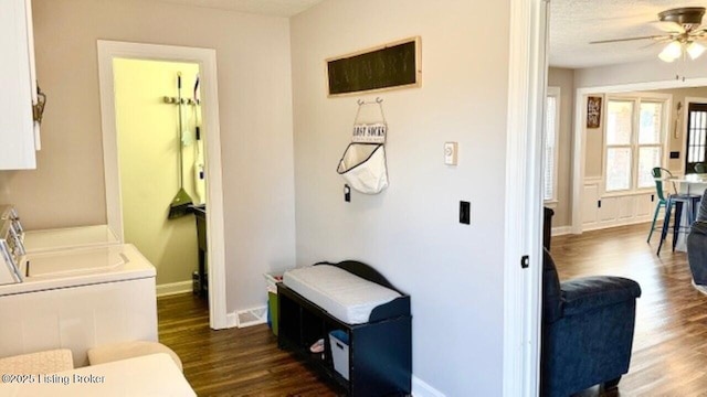 washroom featuring baseboards, dark wood finished floors, laundry area, ceiling fan, and independent washer and dryer