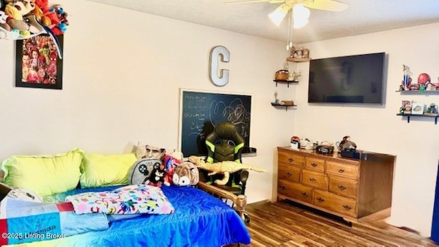 bedroom featuring a ceiling fan and wood finished floors