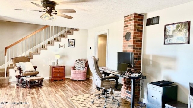 home office featuring baseboards, a textured ceiling, ceiling fan, and wood finished floors