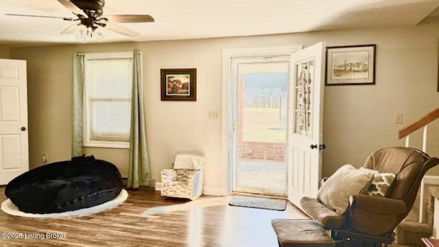 sitting room featuring a ceiling fan and wood finished floors