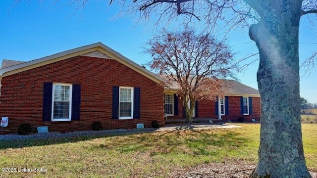 ranch-style home with brick siding and a front lawn