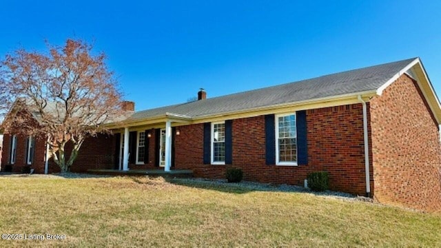 ranch-style house with brick siding and a front lawn