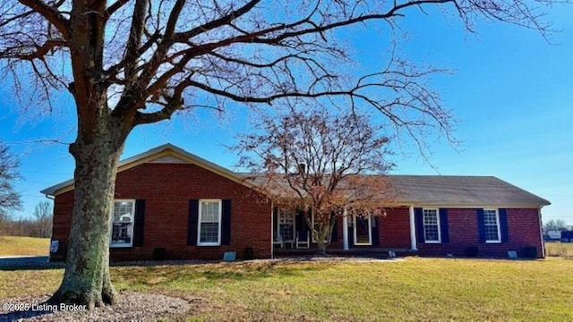 ranch-style home with brick siding and a front yard